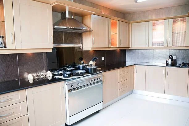 Modern kitchen with a built-in stove and oven appliance being serviced
